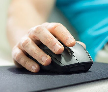 Close up of hands clicking a computer mouse